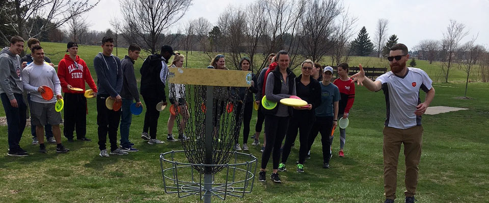 Students playing disc golf. 