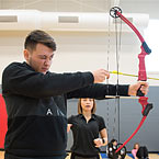 A person prepares to shoot a bow and arrow