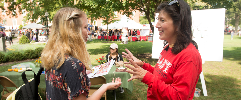 A student speaking with a program representative at Festival I S U.