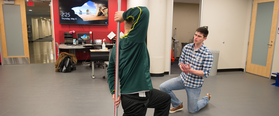 Two students working on a mobility exercise.