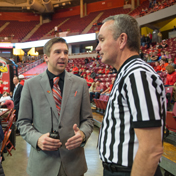 A person speaks to a basketball referee