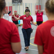 A students leads a group of people in stretching